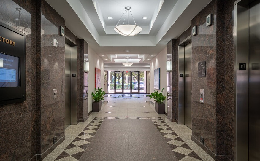 Elevator lobby at 11200 Richmond Ave with granite finishes, looking toward the building entrance
